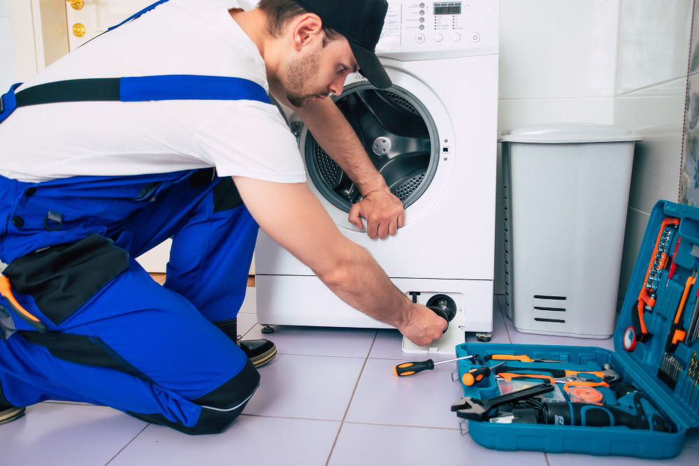 Repair technician checking a tumble dryer.
