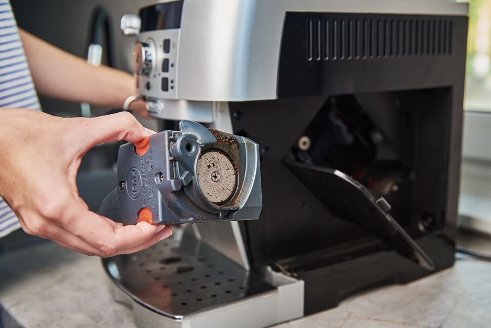 Repair specialist working on a commercial espresso machine.