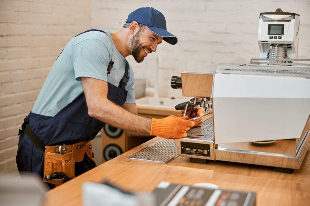 Repair specialist working on a commercial espresso machine.