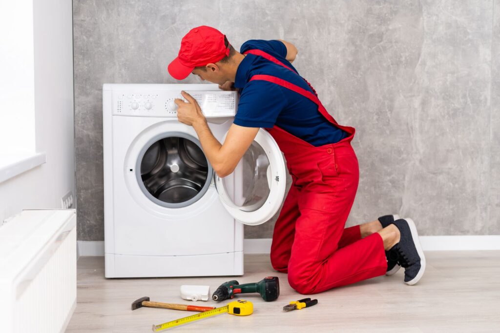 Repair technician checking a tumble dryer.